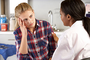 Frustrated teen talking to doctor