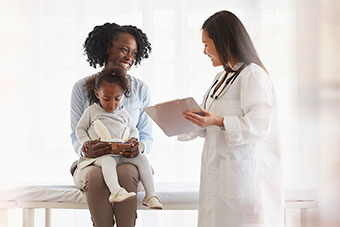 Mom with child talking to doctor