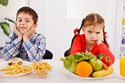 Kids with fast food and healthy food