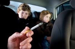 Kids in car with adult smoking